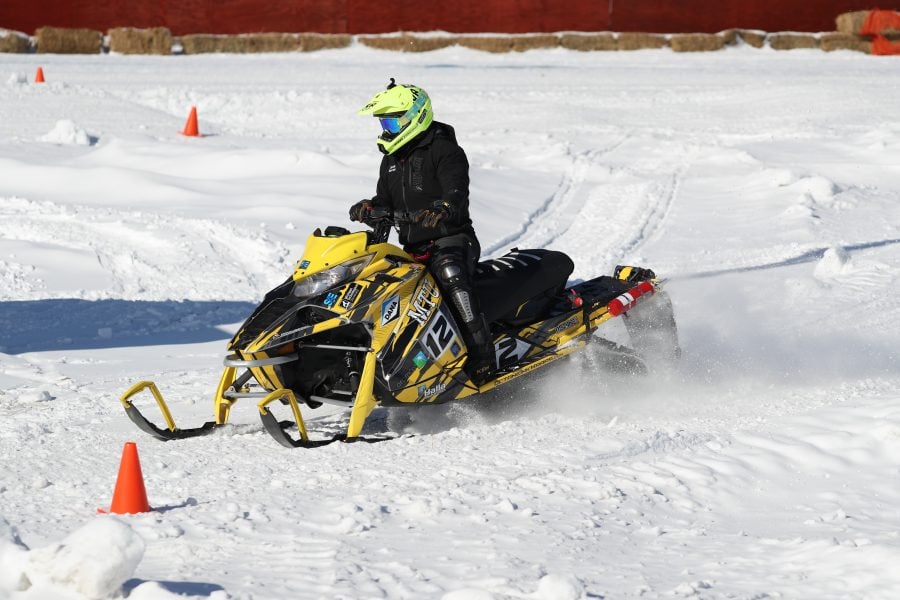 A Michigan Tech-branded snowmobile is driven by an SAE Clean Snowmobile team member in the annual challenge in Eagle River, Wisconsin.