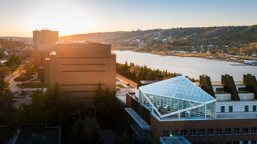 Aerial photograph of Dow Environmental Sciences and Engineering Building and Electrical Energy Resource Center during a sunset; Keweenaw Waterway in the background.