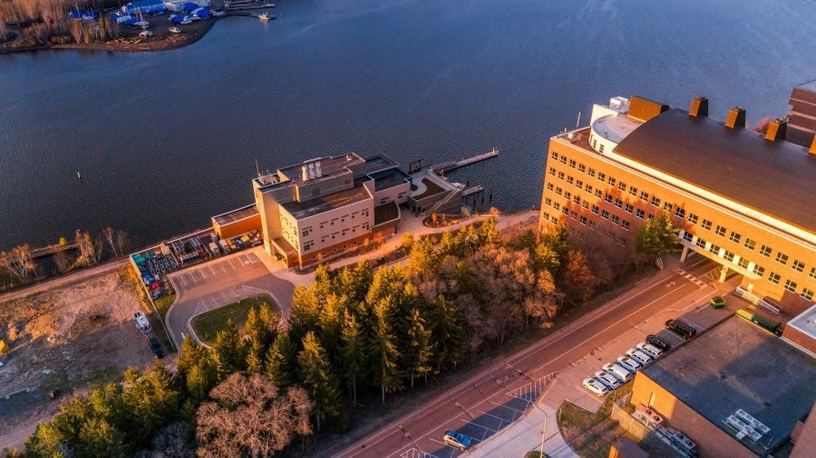 Aerial photograph of Dow Environmental Sciences and Engineering Building and Great Lakes Research Center during a sunset.