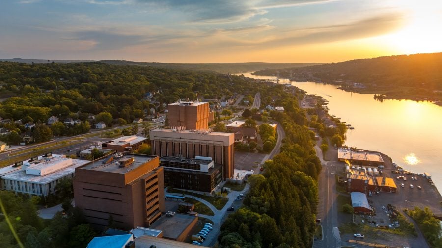 Aerial photo of Michigan Tech’s main campus and Keweenaw Waterway during a sunset.