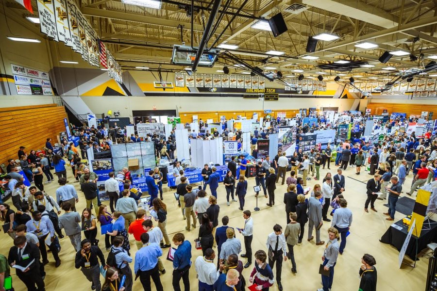 Students and employers mill around by booths and in aisles as hundreds attend Michigan Tech’s Fall Career Fair in the multipurpose room of the SDC in 2024.