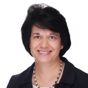 Portrait of Teresa Karjala wearing a white shirt, black jacket, and black and silver necklace.