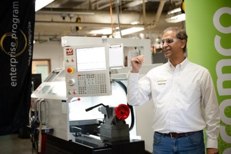 Nagesh Hatti standing in front of the new CNC lathe welcomes everyone