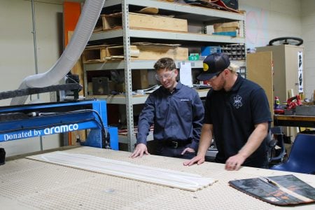 A Michigan Tech student demonstrates the new CNC lathe to Aramco's Andrew Baur