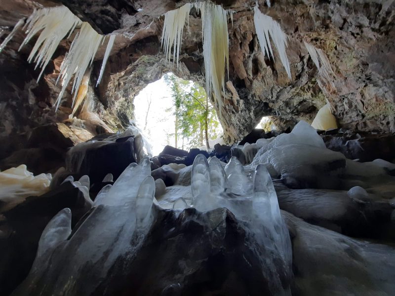 Icicles and ice stalagmites in a small cave