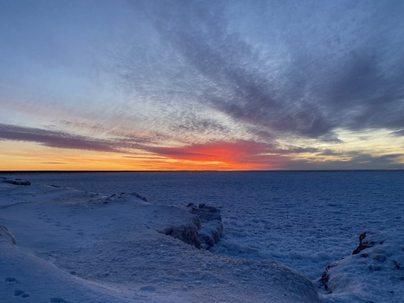 A sunset overlooking a frozen lake