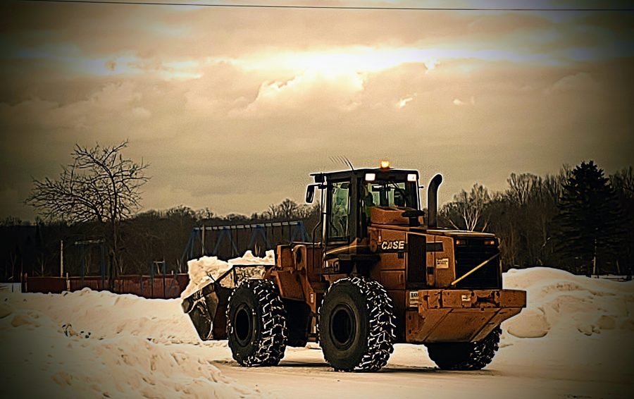 A frontloader removing snow
