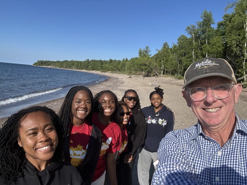 College of Forest Resources and Environmental Science Dean David Flaspohler poses on a sunny beach with six students who attended the SEED program.