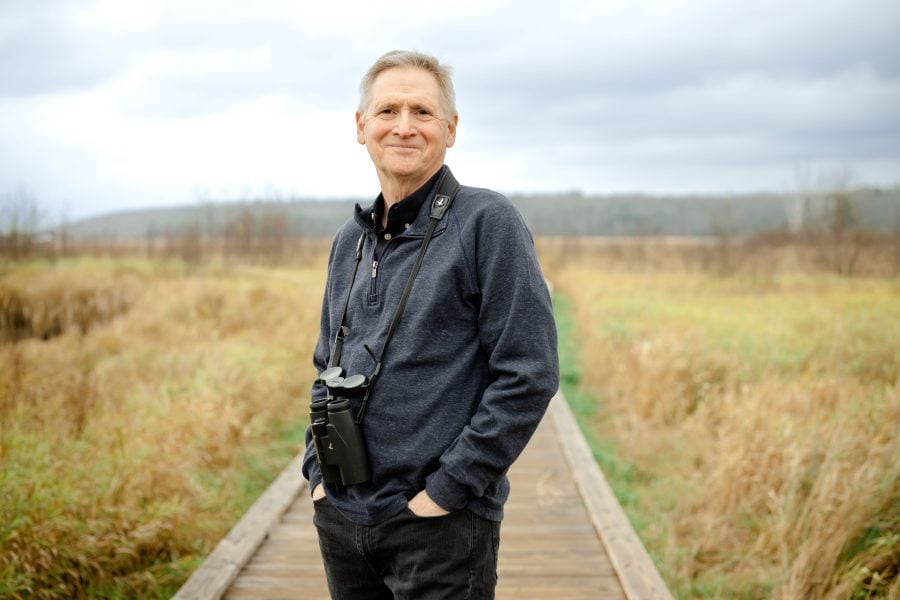 John McCarty stands on the boardwalk at the Nara Trails, a popular birdwatching spot near Michigan Tech’s Campus.