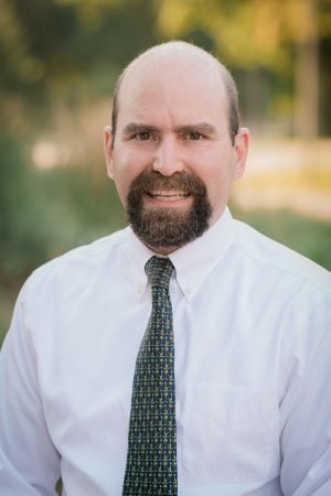 Chris Hohnholt smiles for a portrait.