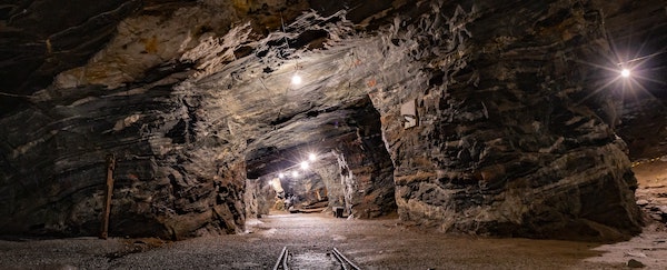 Mine interior with lights and a track.