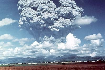 Distant view of an ash cloud from a volcano.