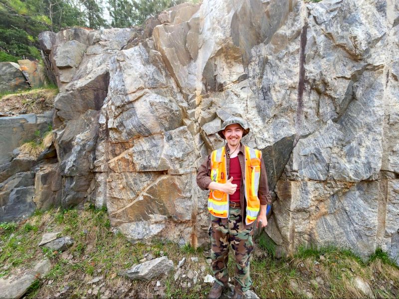 Braxton Murphy stands by a mineral wall.