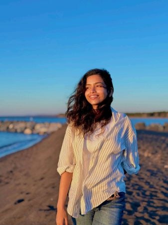 Priyanka walking at sunset along the shore line.