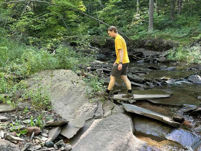 Bryce Baar walking across Swedetown Creek during a GE3100 (Depositional Systems) field trip last Fall.