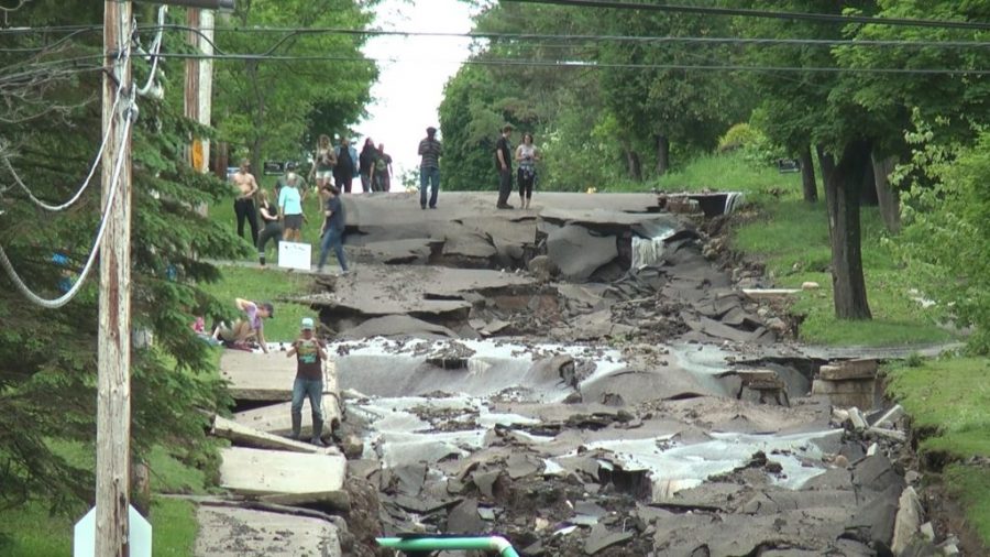 View of Houghton's Agate Street, which is a mess of mud and rubble, after it was destroyed by the Father's Day Flood.