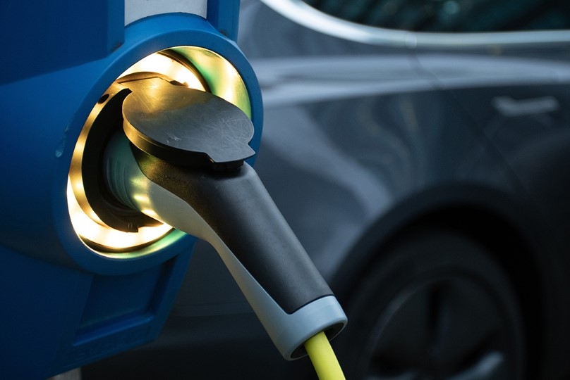 Close up of an electric vehicle being charged.