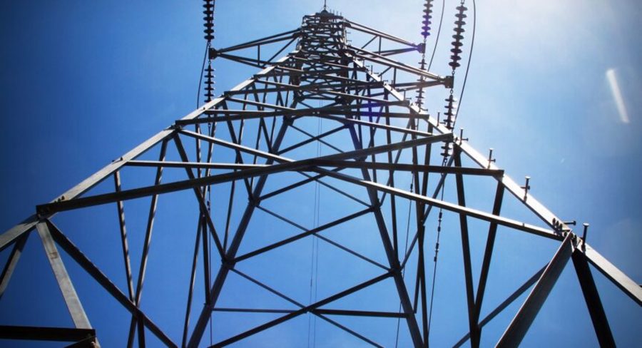 an electric power tower against the blue sky