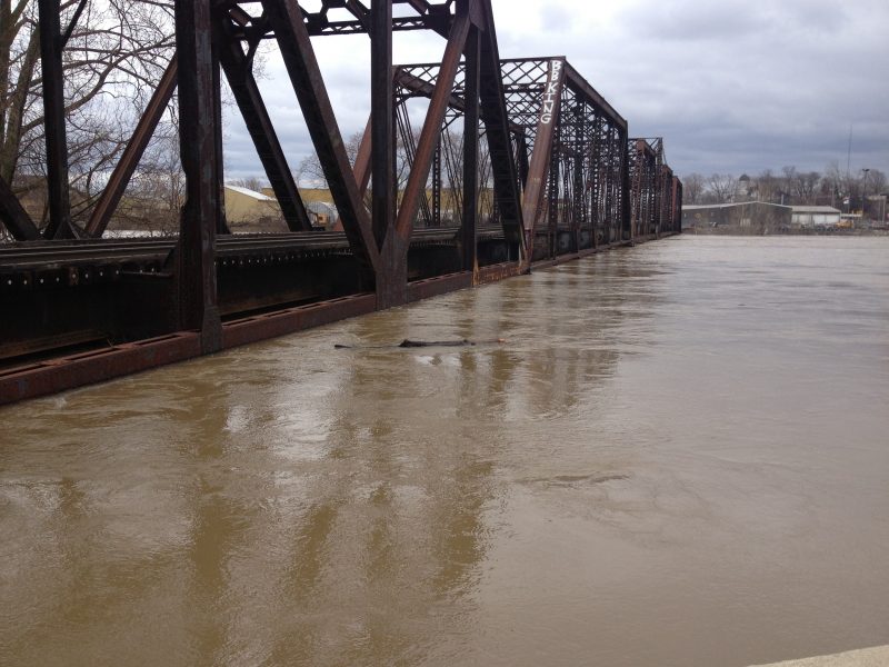 A railroad bridge, an example of a civil asset, inundated with water during the Grand Rapids Flood event.