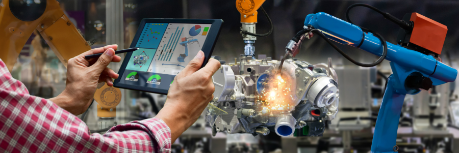 An engineer uses a laptop to solve an advanced manufacturing engineering problem.