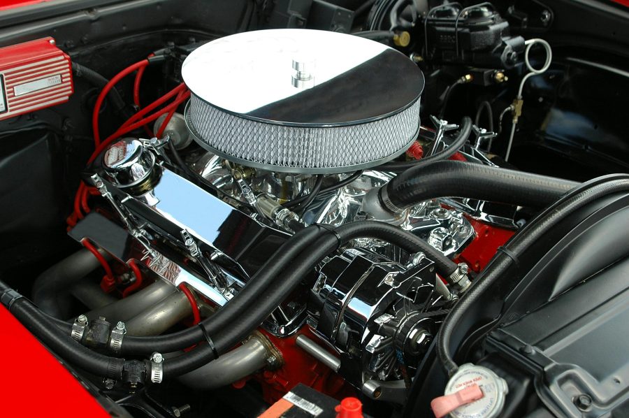 Close up of a shiny IC engine in a red car.