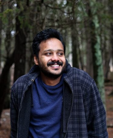 Nithin Allwayin outdoors in a shady wooded area