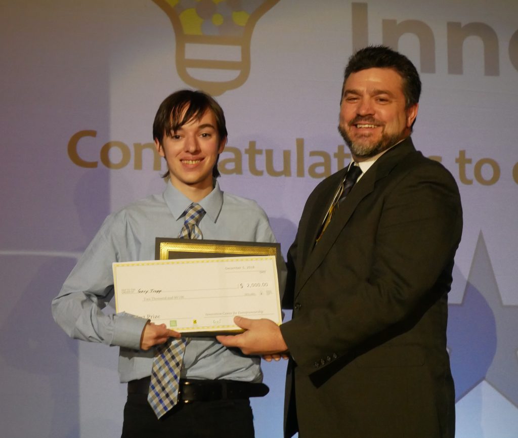 Pavlis Honors student, Gary Tropp accepts the First Place award from Dean Johnson. Tropp also won the MTEC SmartZone Game Changer award. 