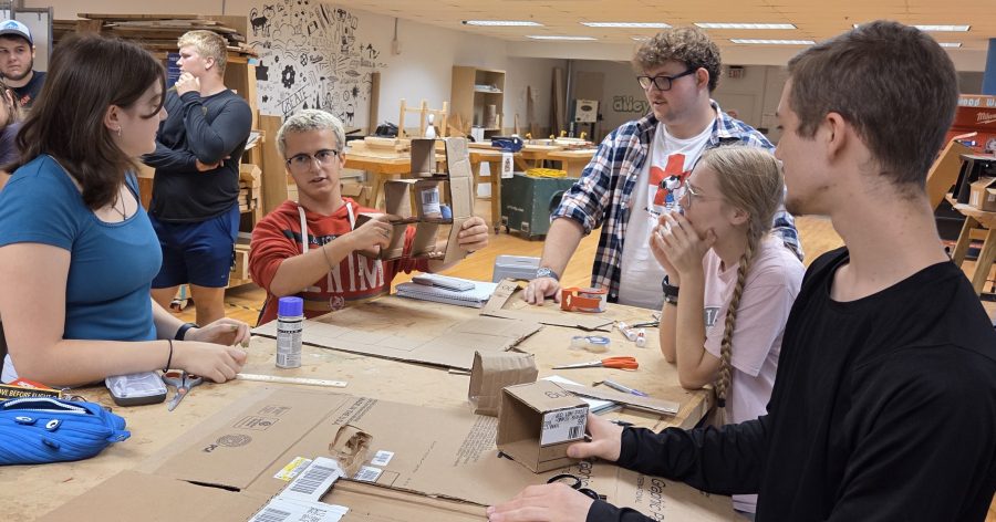 Students share their cardboard prototype.