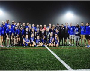 Grand Rapids Football Club posing for a photo on the field at night.