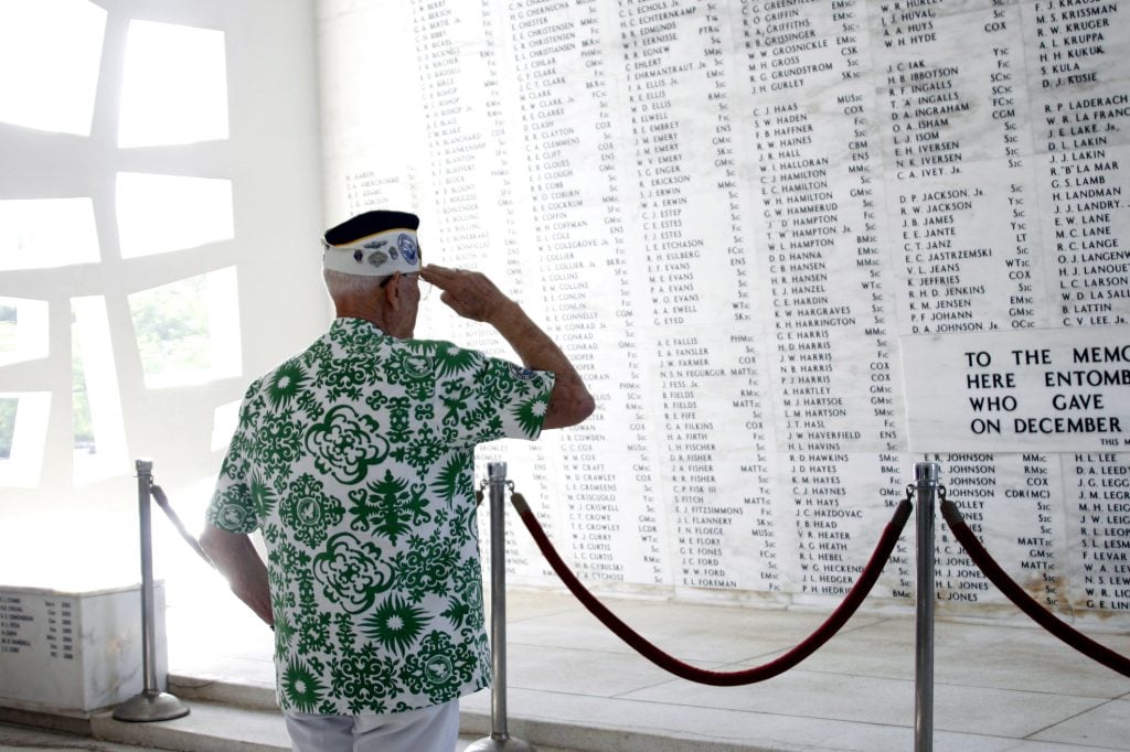 Sterling R. Cale, treasurer, Pearl Harbor Survivors Association Unit 1, salutes his fallen comrades in the rear of the USS Arizona Memorial Monday during the Memorial Ceremony and Interment of James Evans Cory, the first Marine to be buried aboard the Arizona since World War II.