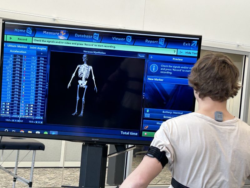 man hooked up to sensors with his movements displayed on a monitor