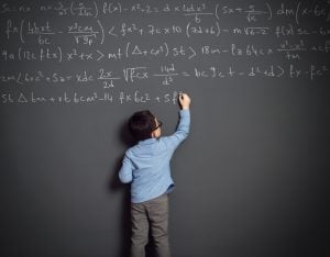 Little child in front of huge blackboard