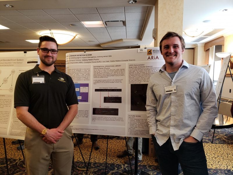 Image of Anthony Palmer and Elijah Cobb with their poster at Michigan Tech’s Computing Showcase