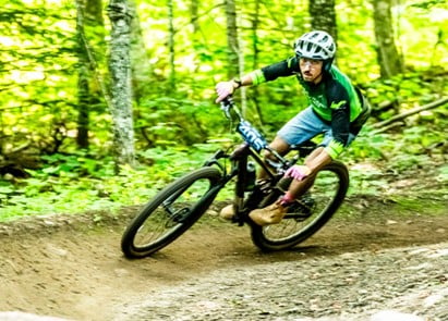 Murphy Mallow riding on dirt trail on mountain bike