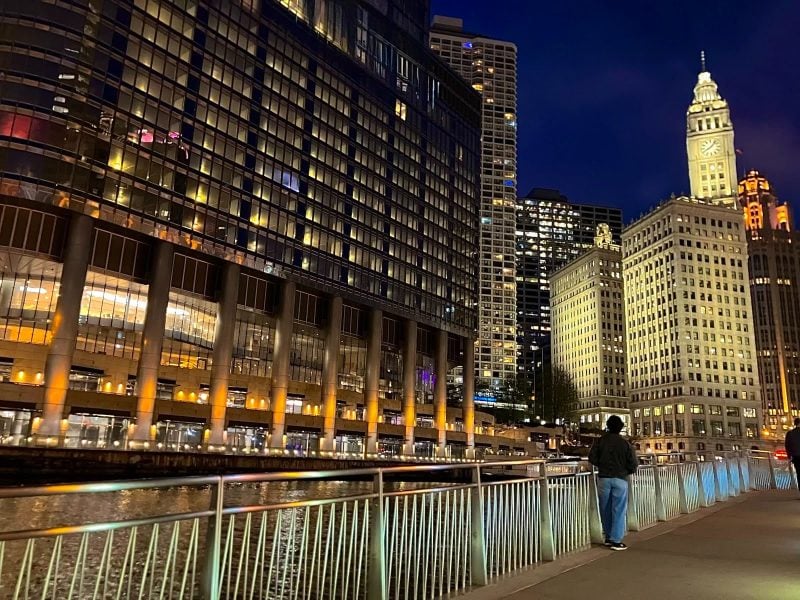 Viviana Cotter walking along a river in Chicago at night 