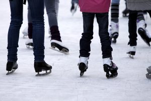 Feet with skates on an ice rink