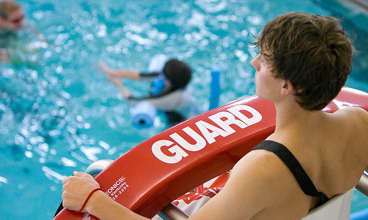 lifeguard watching pool patrons