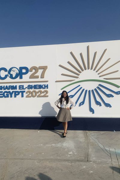 Kathy Huerta Sanchez stands in front of the COP27 sign in Sharm El-Sheik.