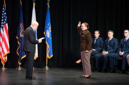 ROTC graduate raises right hand to take the oath