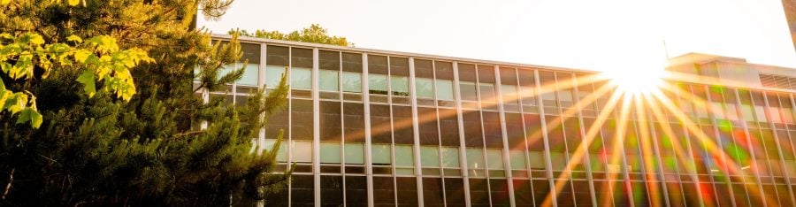 Sun shining over the exterior of Fisher Hall.