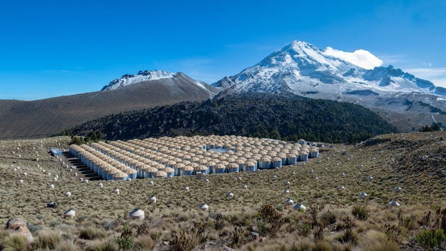 View of the HAWC Observatory with mountains in the background