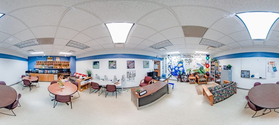 A panoramic view of the Biological Sciences Learning Center shows tables and couches for studying, mini-lab tables, bookshelves and multiple resource shelves.