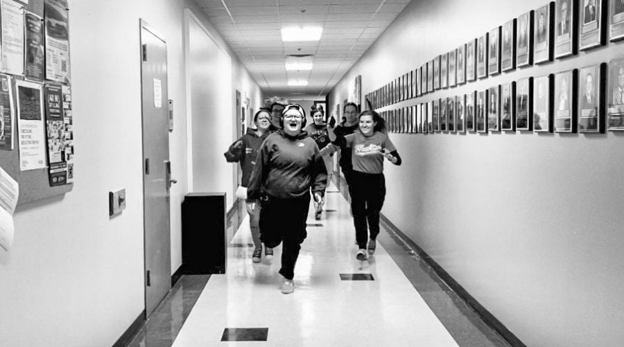 Black and white. Sound Girls student members run down a hallway chasing fellow student Jos Olson towards the camera in this still from the groups’ short film.