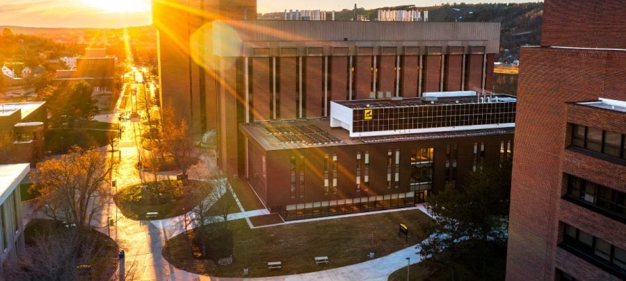 An aerial view of Michigan Tech’s campus with the H-STEM building in the foreground during a brilliant golden sunrise.