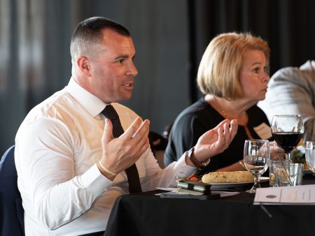 Steven Fantetti talks with faculty, staff, and guests over dinner at the Academy of Sciences and Arts induction ceremony.