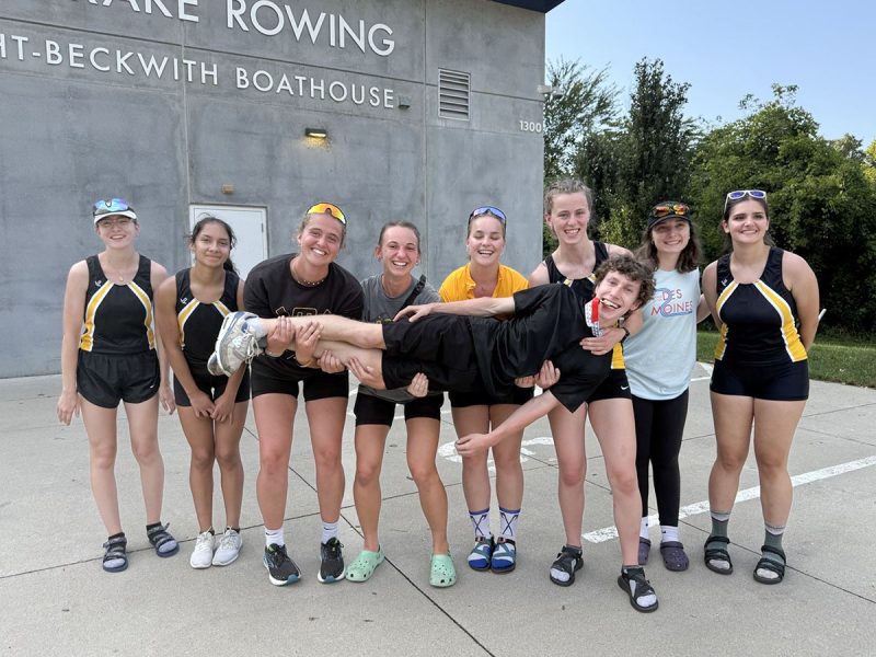 Aili Toyli and eight other members of Tech’s rowing club pose for a photo in front of the boathouse, lifting one of their teammates in a silly pose.