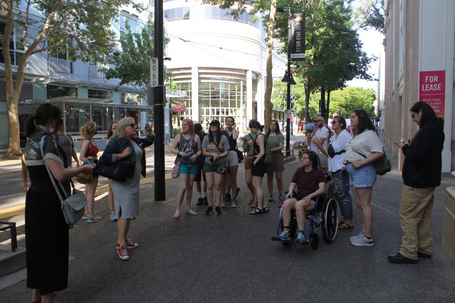 Students gathered around a tour guide named Dawnie Anorak