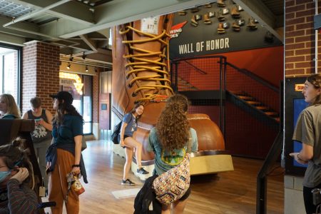 Students surround the world's largest leather boot