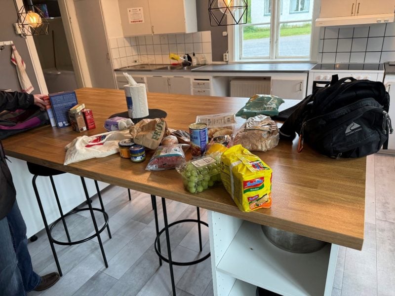 various groceries and bags sitting on a kitchen island