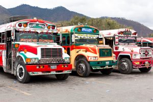 Antigua - Guatemala - January 24, 2013: Traditional Guatemalan local "Chicken Bus" station in Antigua, Guatemala. It is located behind the busy street market in Antigua.